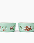 2 teal ceramic ramekins with black characters in Christmas and holiday snow scenes