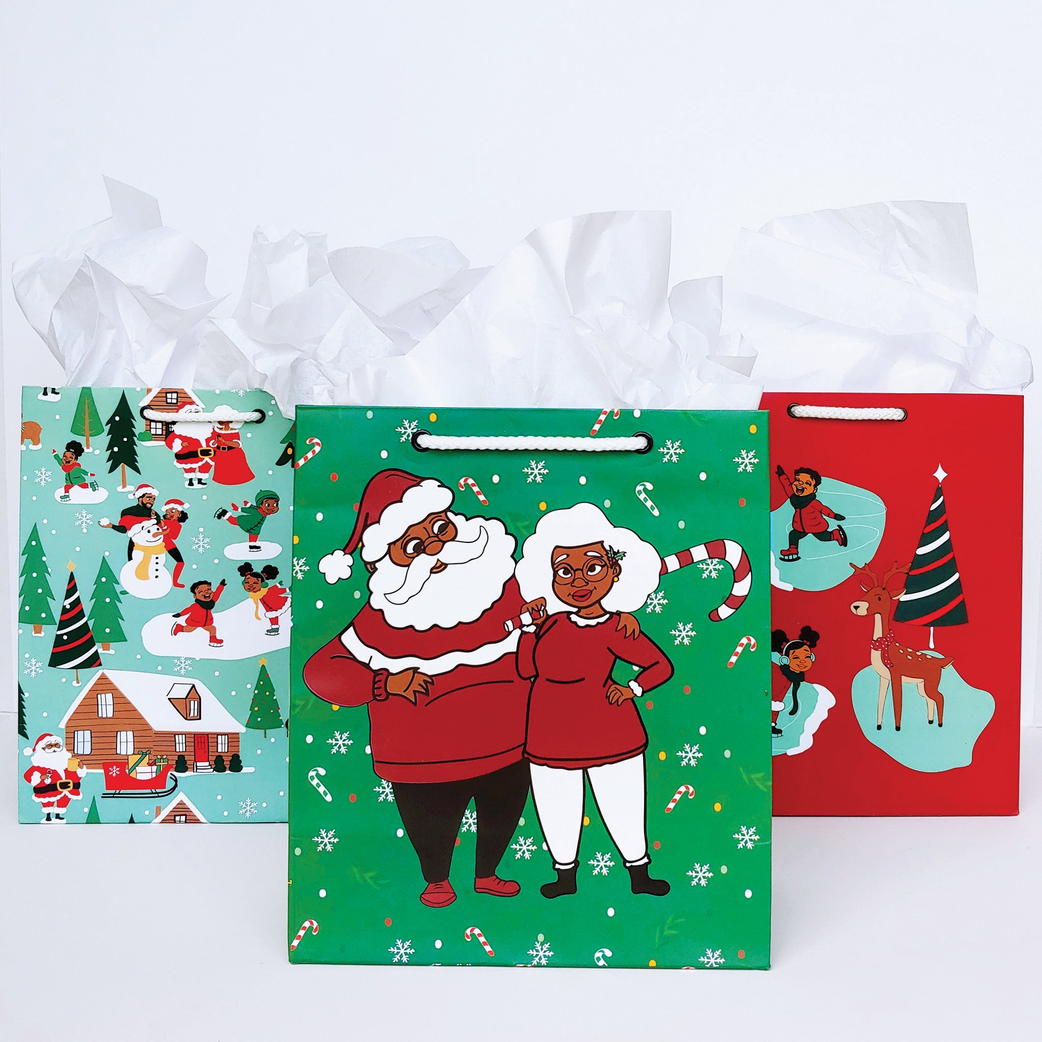 a collection os 3 holiday gift bags all adorned with black people illustrations. 
