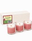 Black Paper Party Nana’s Kitchen three-candle gift set with red gingham glass vessels and a linen gift box.
