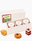 Nana’s Kitchen candles in an open gift box beside cake and cornbread fragrance props.