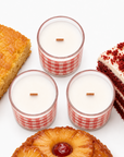 Overhead view of three Nana’s Kitchen candles with wood wicks and cake-inspired props.