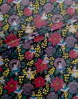 Noire Noel gift wrap with a dark floral pattern.