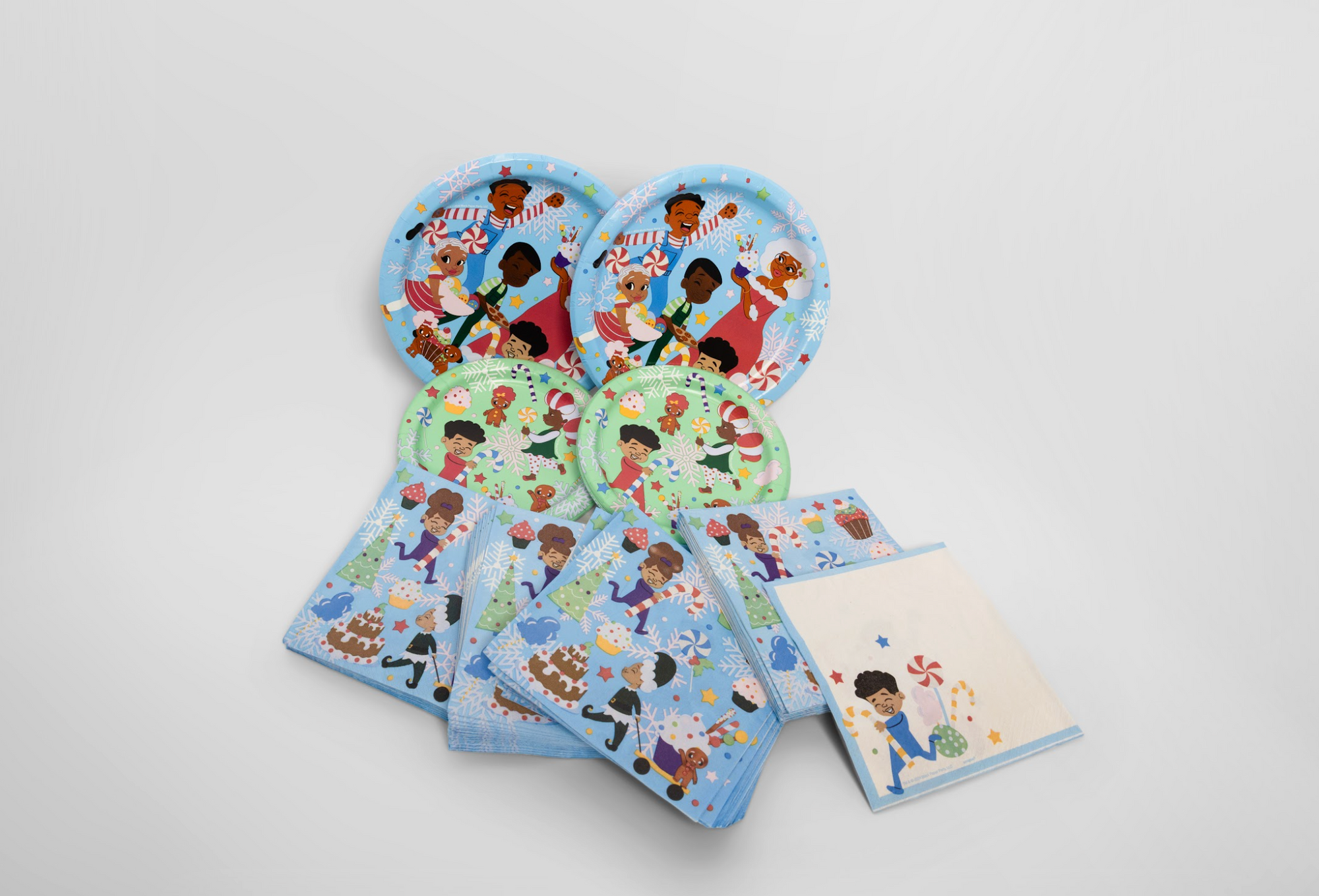 Set of children's party plates and napkins with cartoon characters on a white background