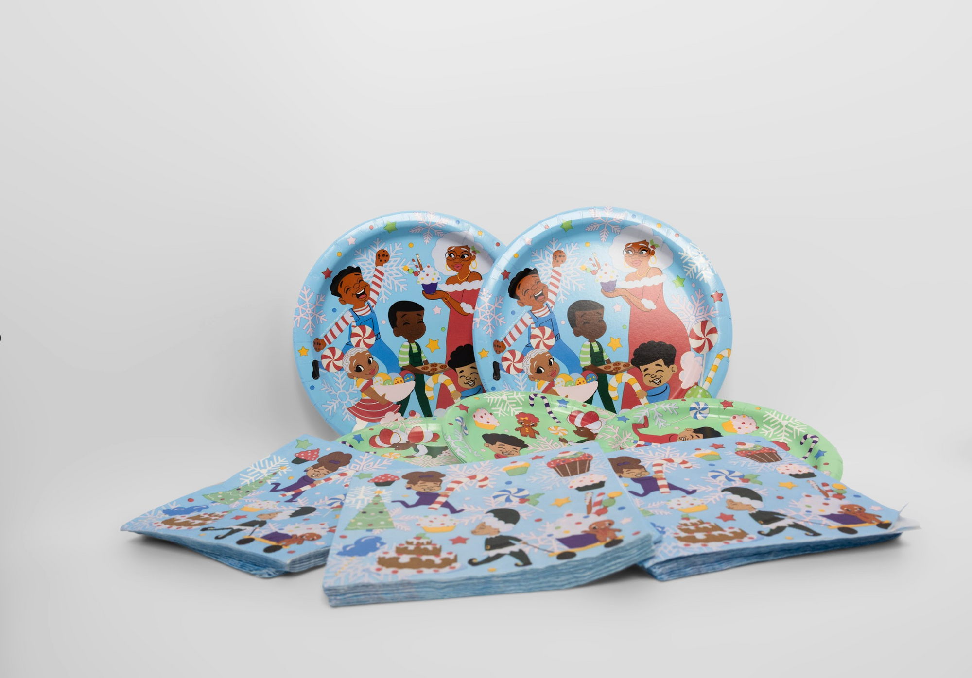 Set of paper plates and napkins with festive designs on a white background