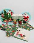 Christmas-themed paper plates, cups, and napkins on a white background