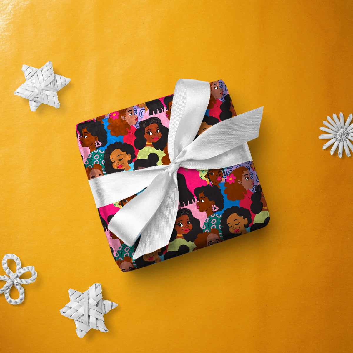 Gift box wrapped in Women Multi gift wrap with a white ribbon