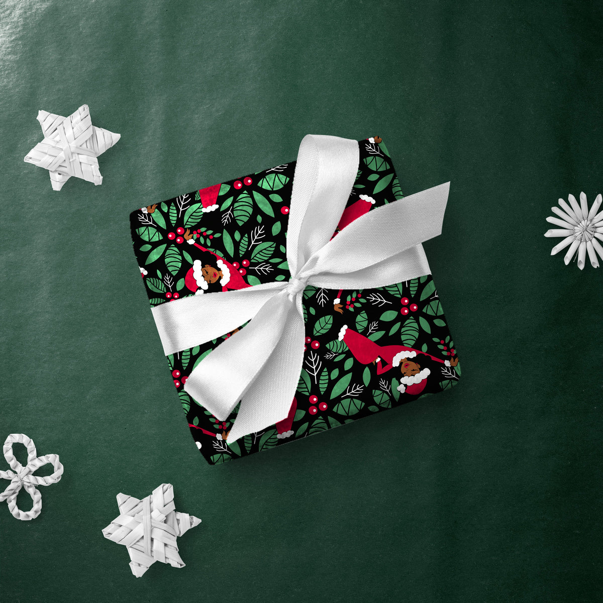 Gift box wrapped in Aunt Holly Mistletoe gift wrap with a white ribbon
