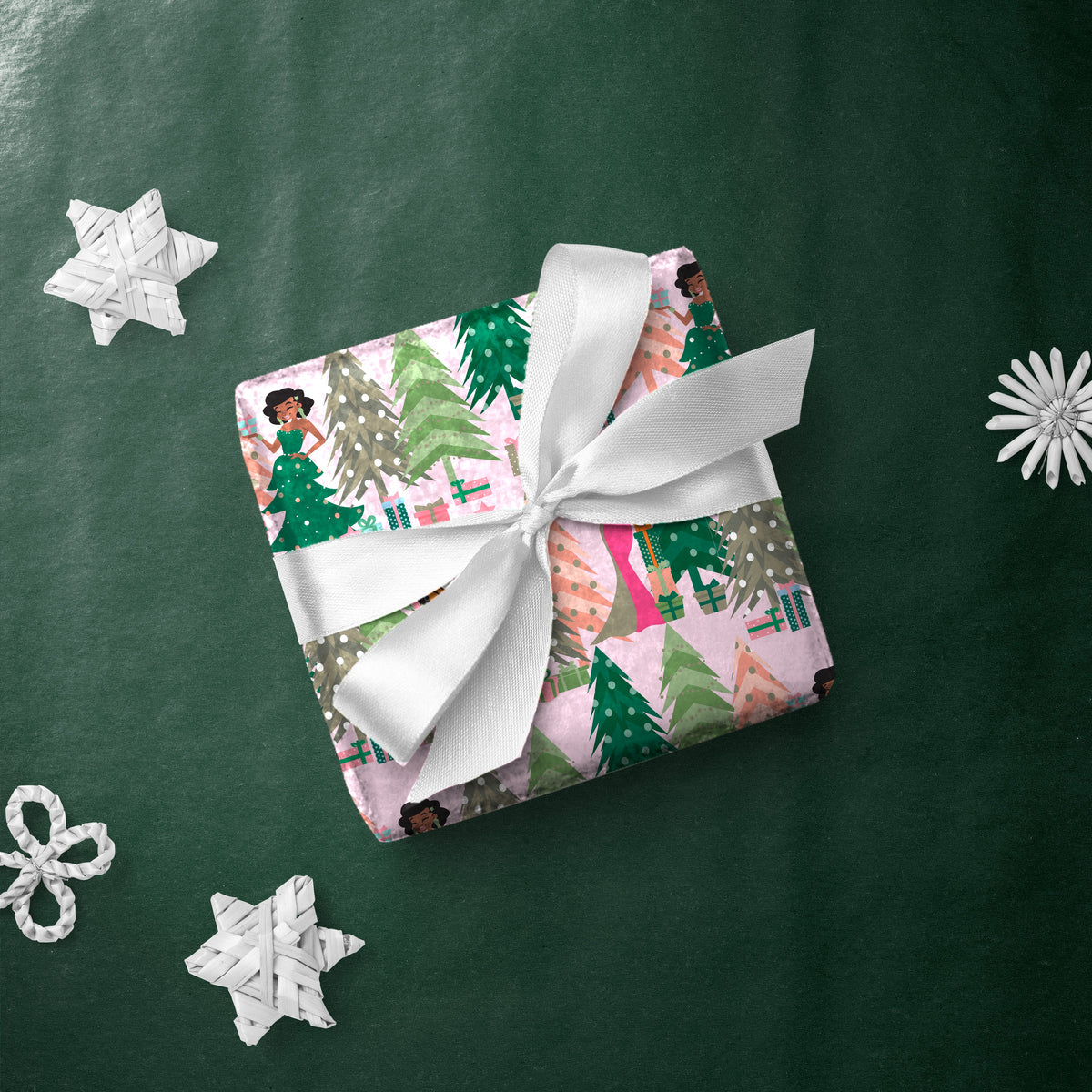 Gift box wrapped in Aunt Holly Tree gift wrap with a white ribbon