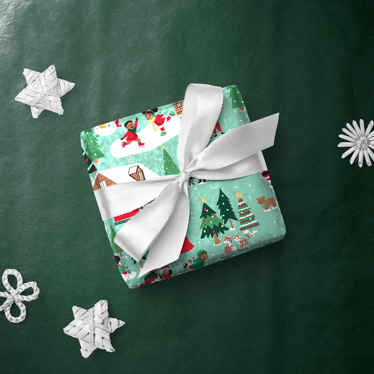 Gift box wrapped in Family Winter Scene gift wrap with a white ribbon
