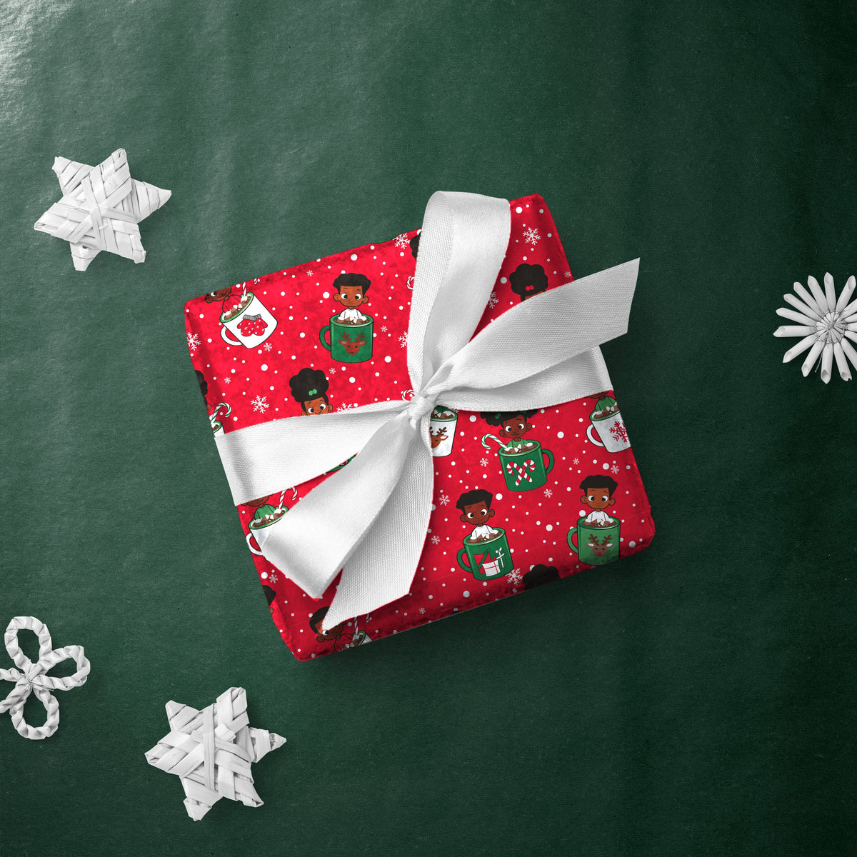 Gift box wrapped in Kids in Mugs gift wrap with a white ribbon