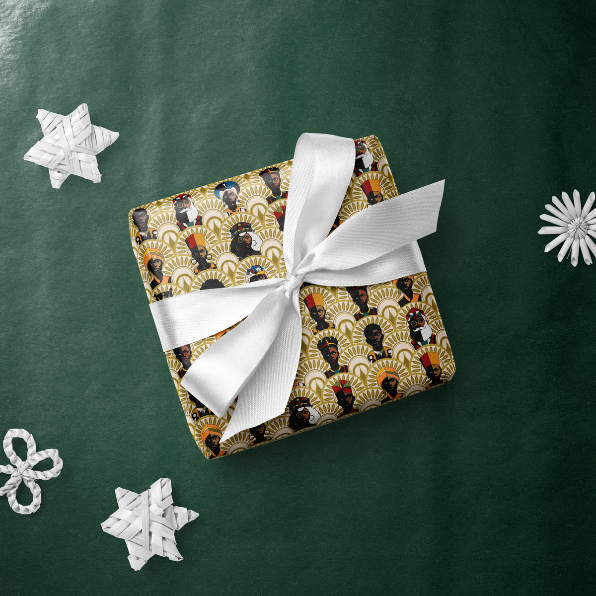 Gift box wrapped in Kings and Queens gift wrap with a white ribbon