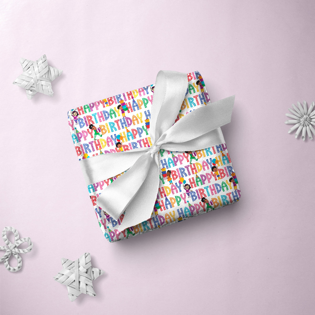 Gift box wrapped in Happy Birthday Letters gift wrap with a white ribbon