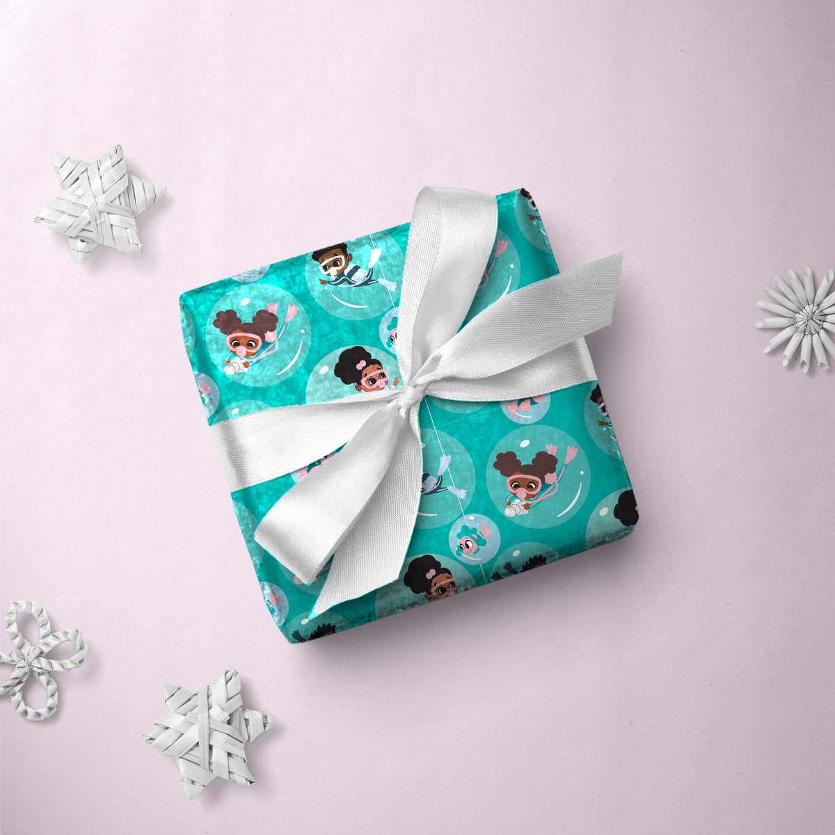 Gift box wrapped in Scuba Explorers gift wrap with a white ribbon