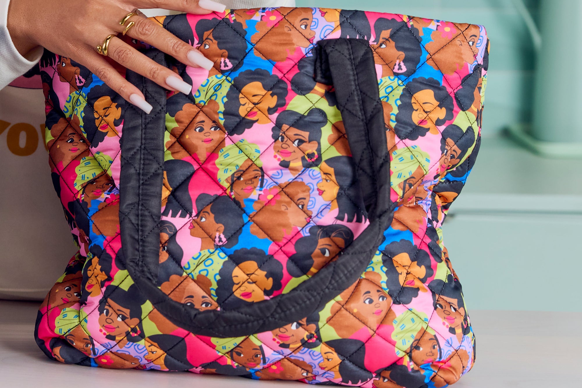 Person holding two patterned bags and a water bottle in a kitchen setting