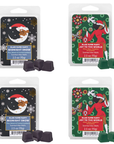 Four packages of scented wax melts with festive designs and branding.
