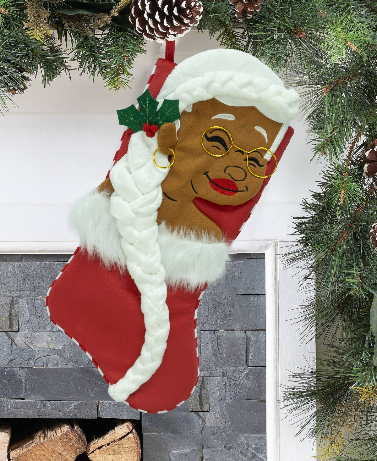 Nana Klaus Letters to Santa red holiday stocking hanging by a fireplace.