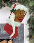 Nana Klaus Letters to Santa red holiday stocking hanging by a fireplace.