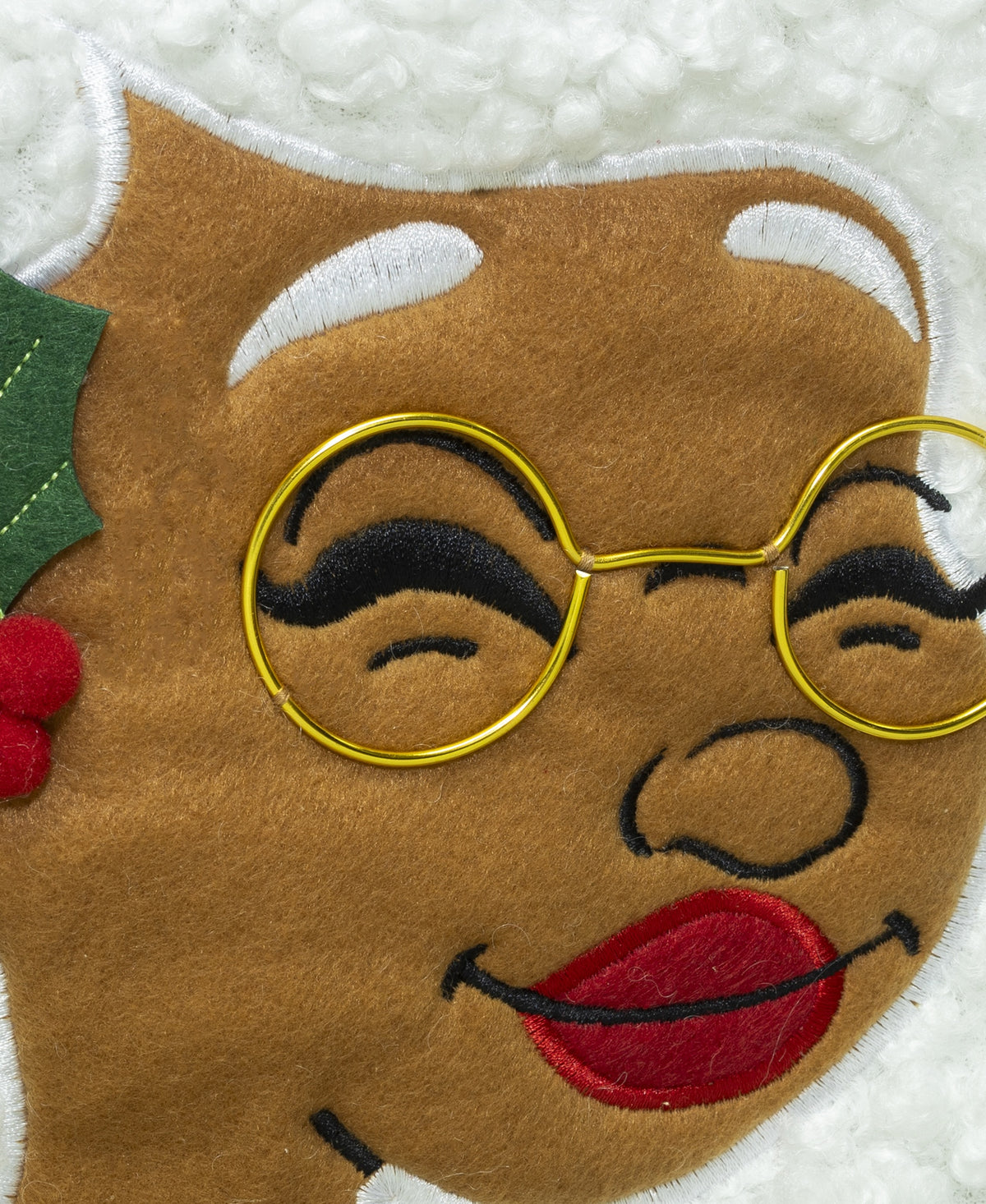 Close-up of Nana Klaus with gold glasses and white hair on the Noire Noel stocking.
