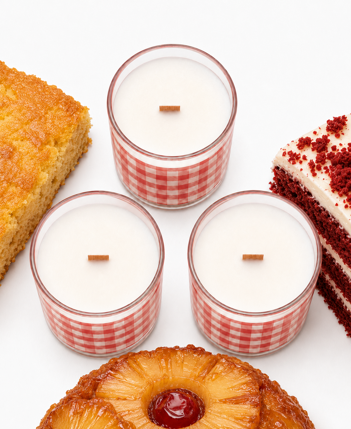 Overhead view of three Nana’s Kitchen candles with wood wicks and cake-inspired props.