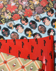 Four coordinating Noire Noel gift wrap patterns featuring Santa, elegant couples, portraits and dark florals.