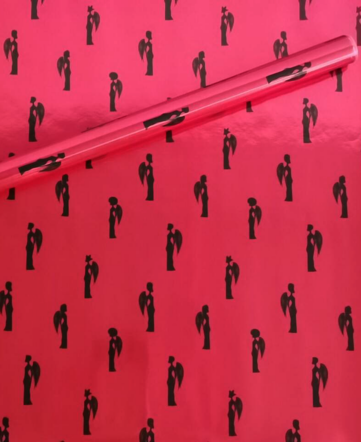 Noire Noel gift wrap with elegant Black couples illustrated on a magenta background.