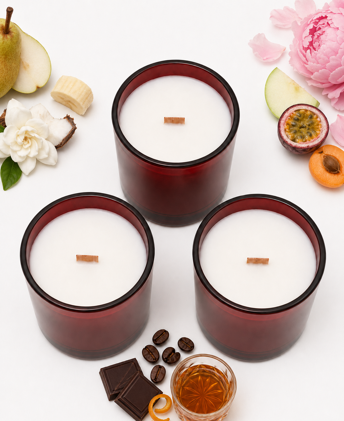 Overhead view of three Noire Noel candles with wood wicks and fragrance-inspired props.