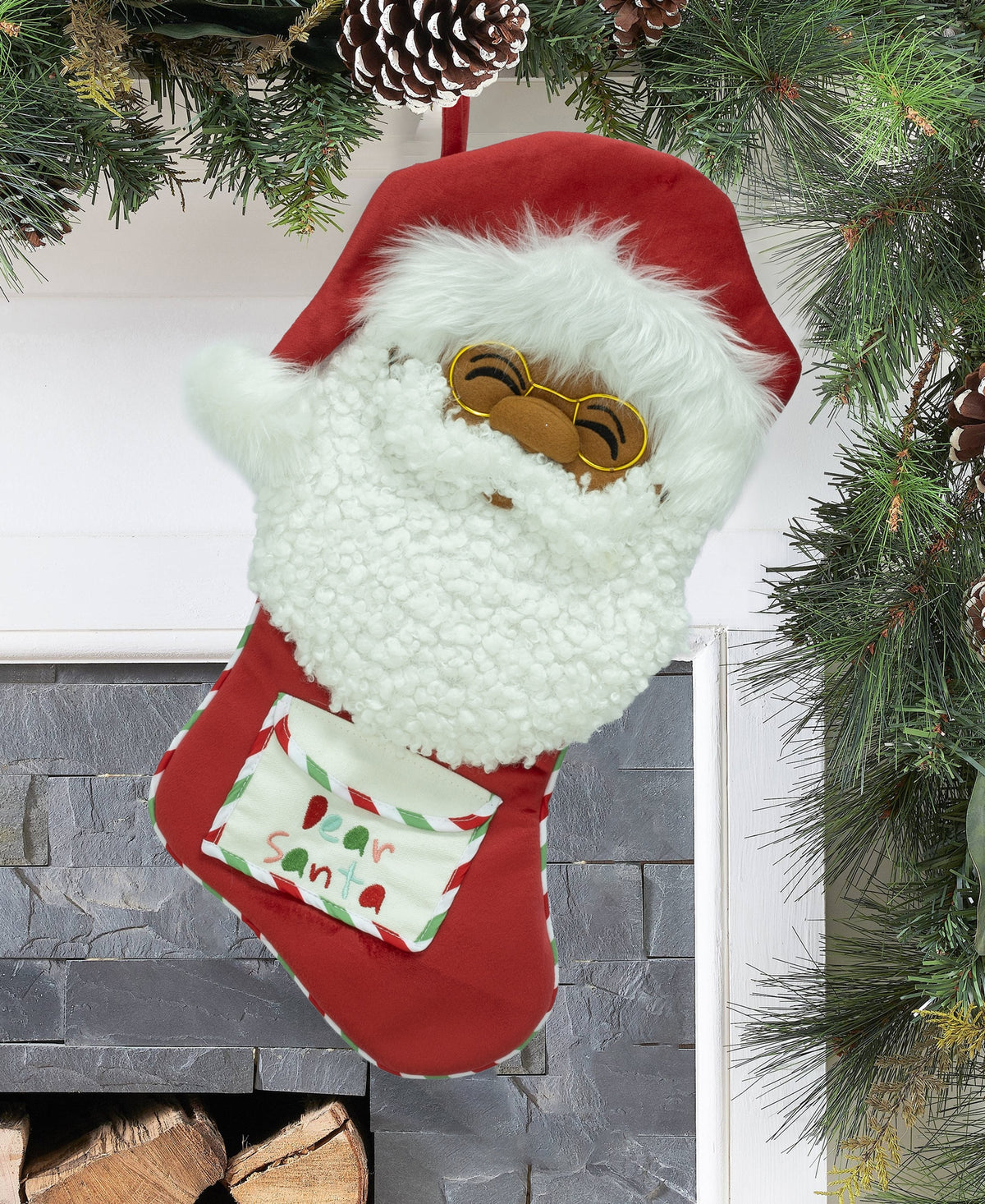 Papa Klaus Letters to Santa red holiday stocking hanging by a fireplace.