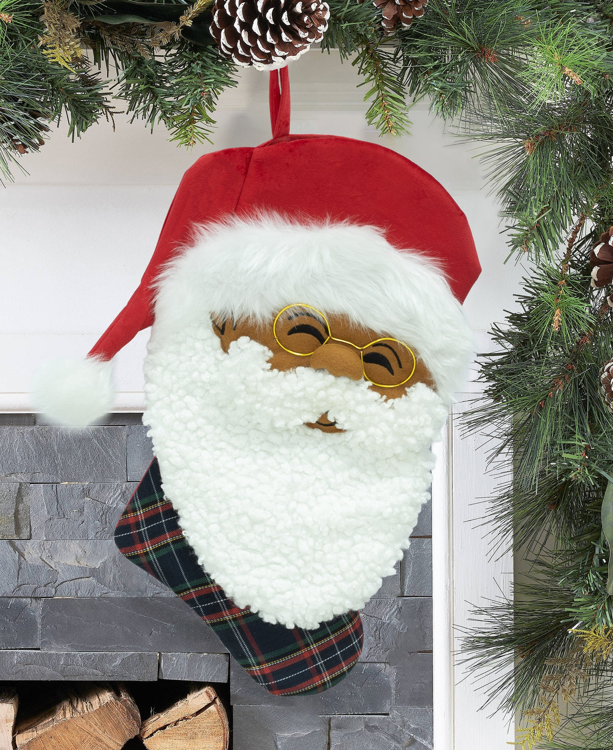 Papa Klaus Noire Noel plaid holiday stocking hanging by a fireplace.