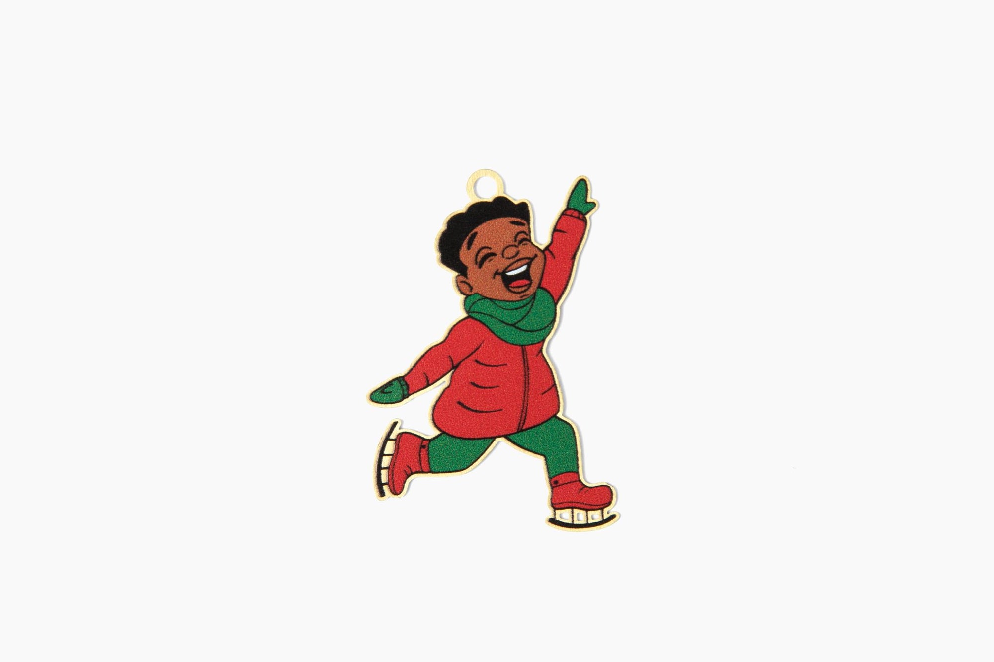 an ornament front featuring  a young black boy smiling and wearing a red coat , green scarf, and ice skates
