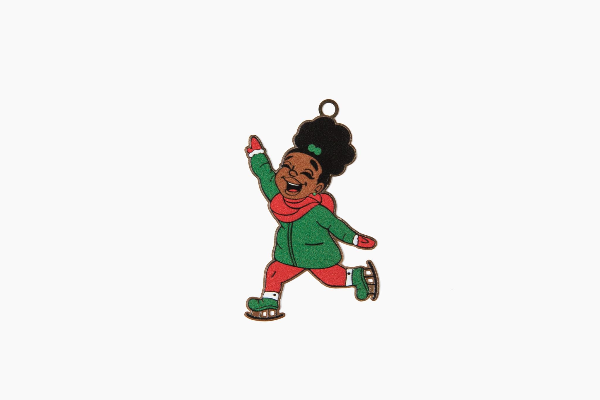 an ornament front featuring a young black girl smiling and wearing a green coat with ice skates